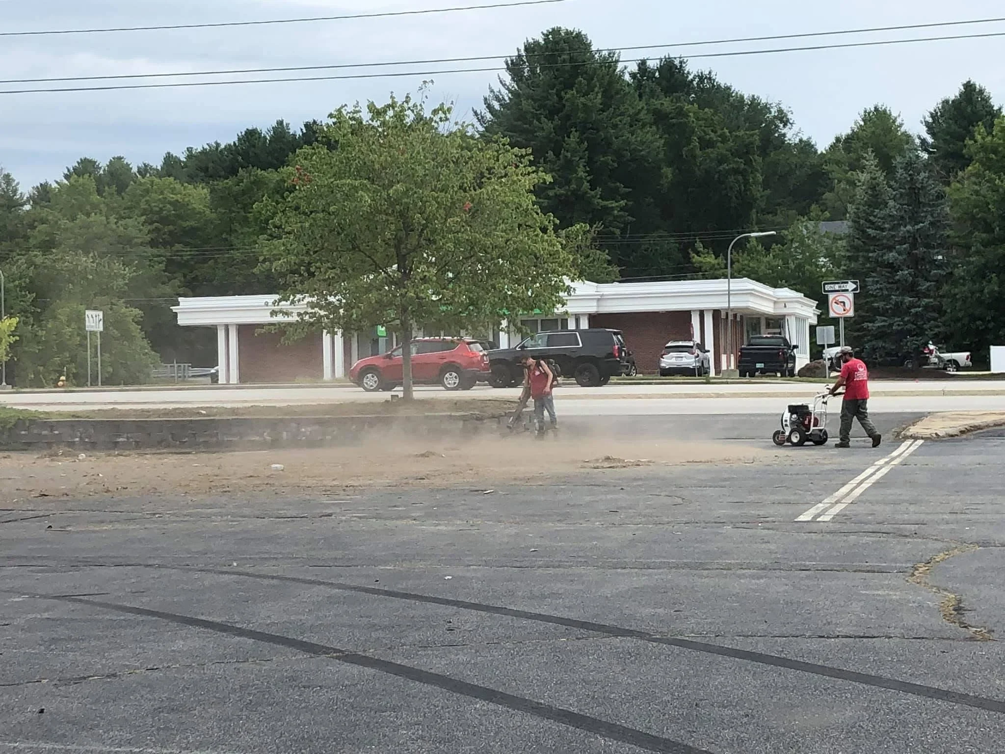 Parking lot grading and preparation with power equipment on commercial property