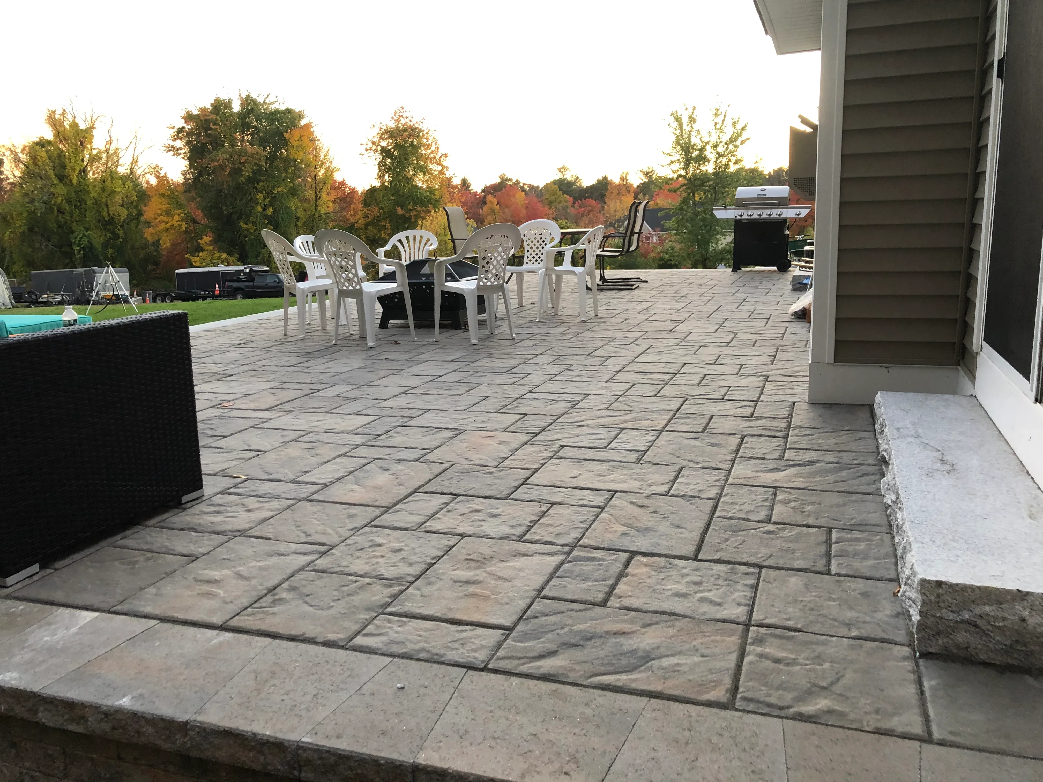 Large concrete paver patio with running bond pattern and integrated outdoor entertaining space