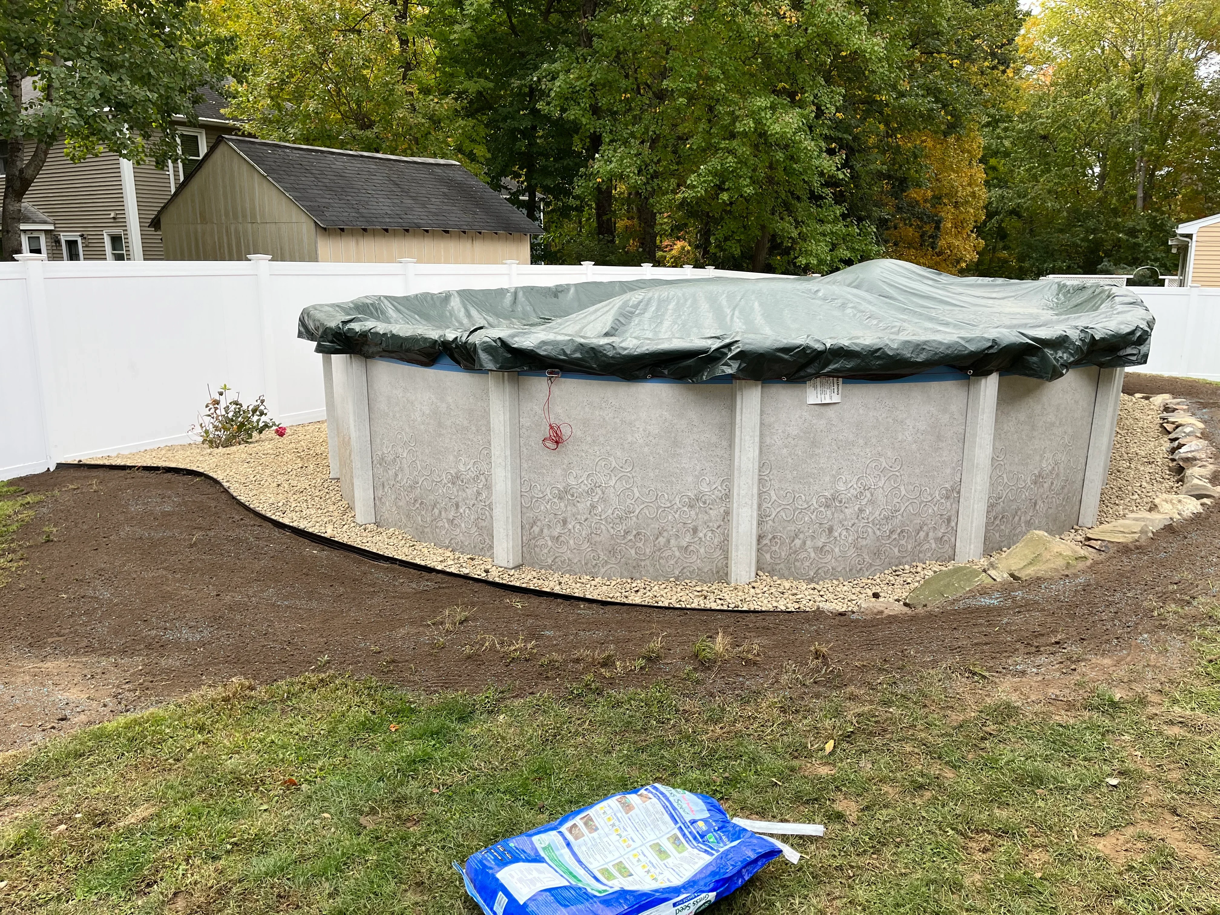 Above-ground pool with concrete walls, vinyl cover, and gravel base installation